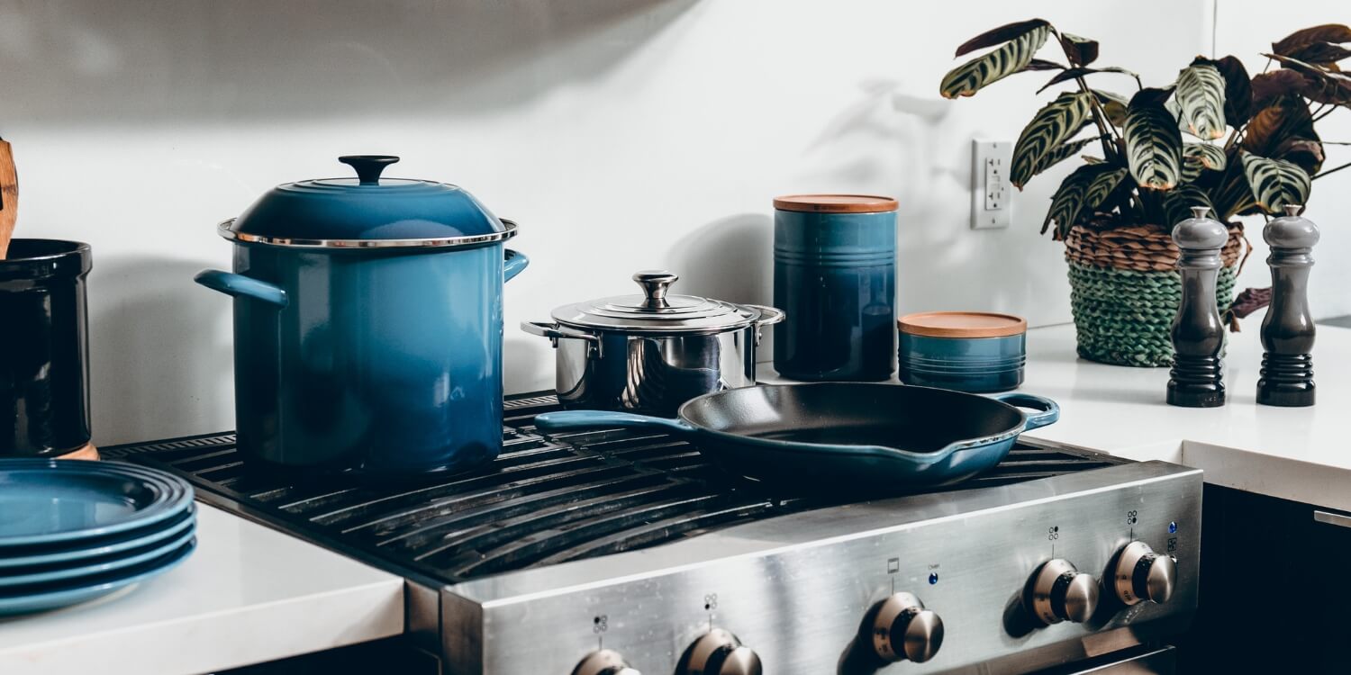 Blauwe pannen en potten op een gasfornuis